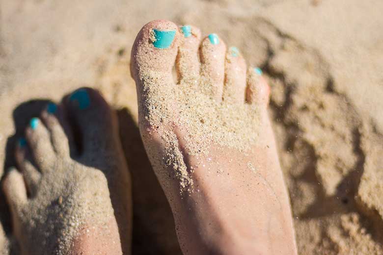 A pair of feet in the sand